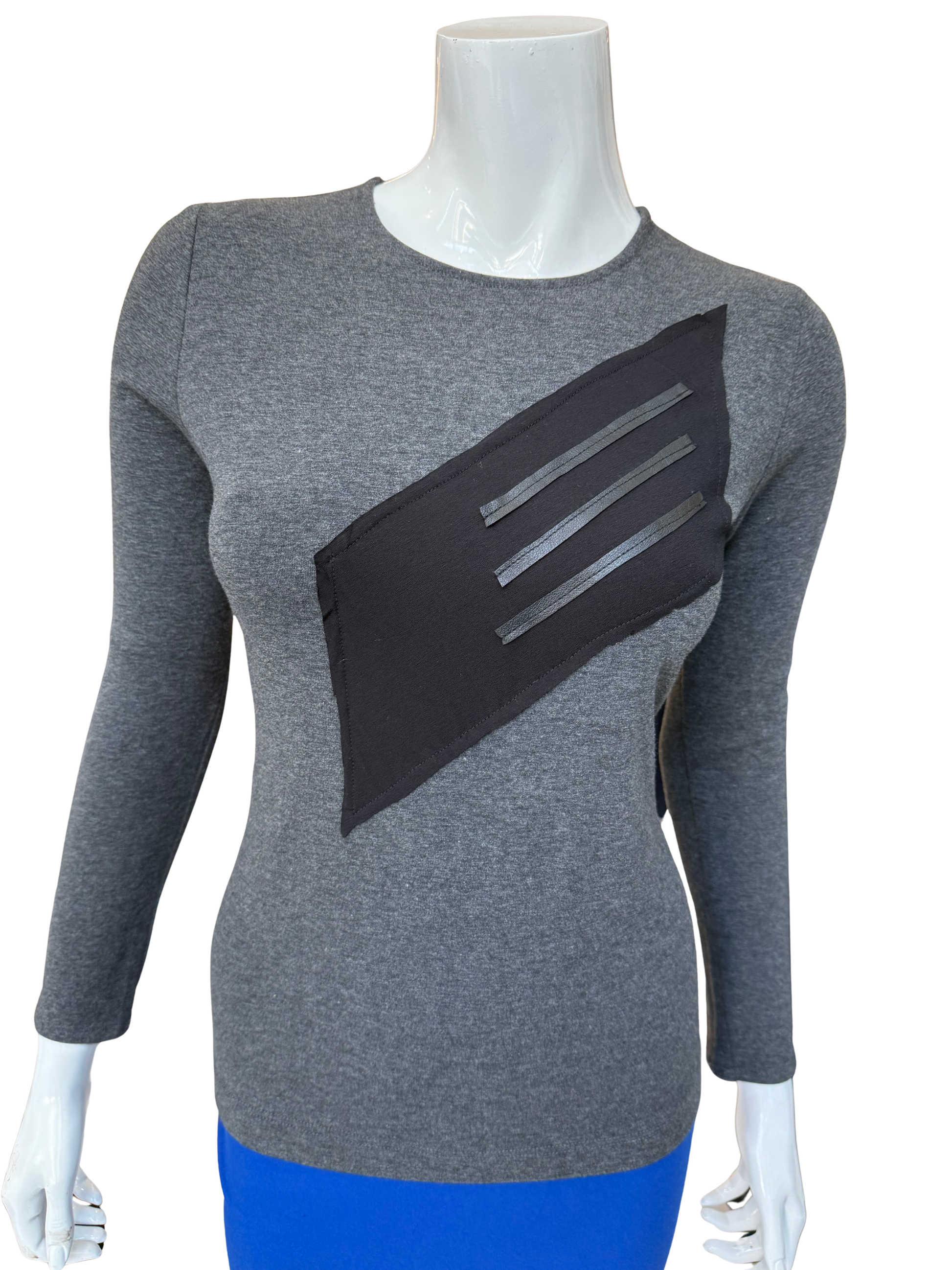 Front view of distinctive cotton lycra top in charcoal featuring bold diagonal washable leather trim panel with long sleeves and contemporary geometric design