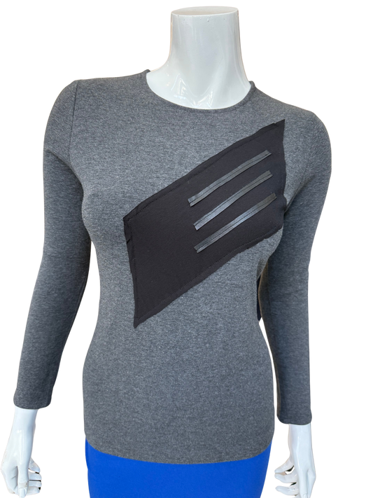 Front view of distinctive cotton lycra top in charcoal featuring bold diagonal washable leather trim panel with long sleeves and contemporary geometric design