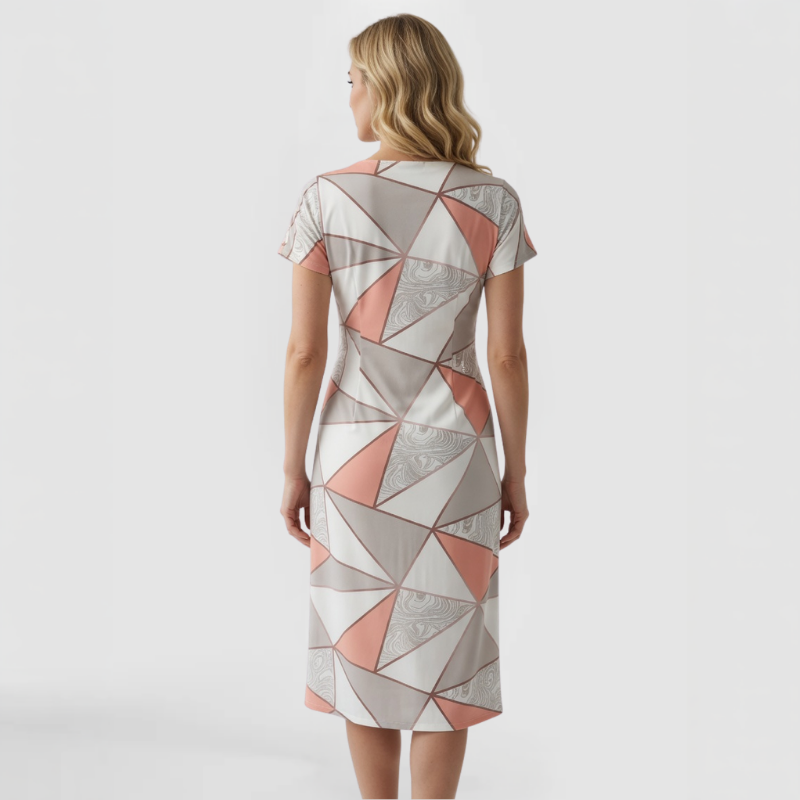 Back view of charmeuse stretch dress showing continuous geometric triangle print in pink, gray, and white wrapping fully around the garment with consistent marbled texture throughout. Made by SWABY - A Chicago Fashion Designer.