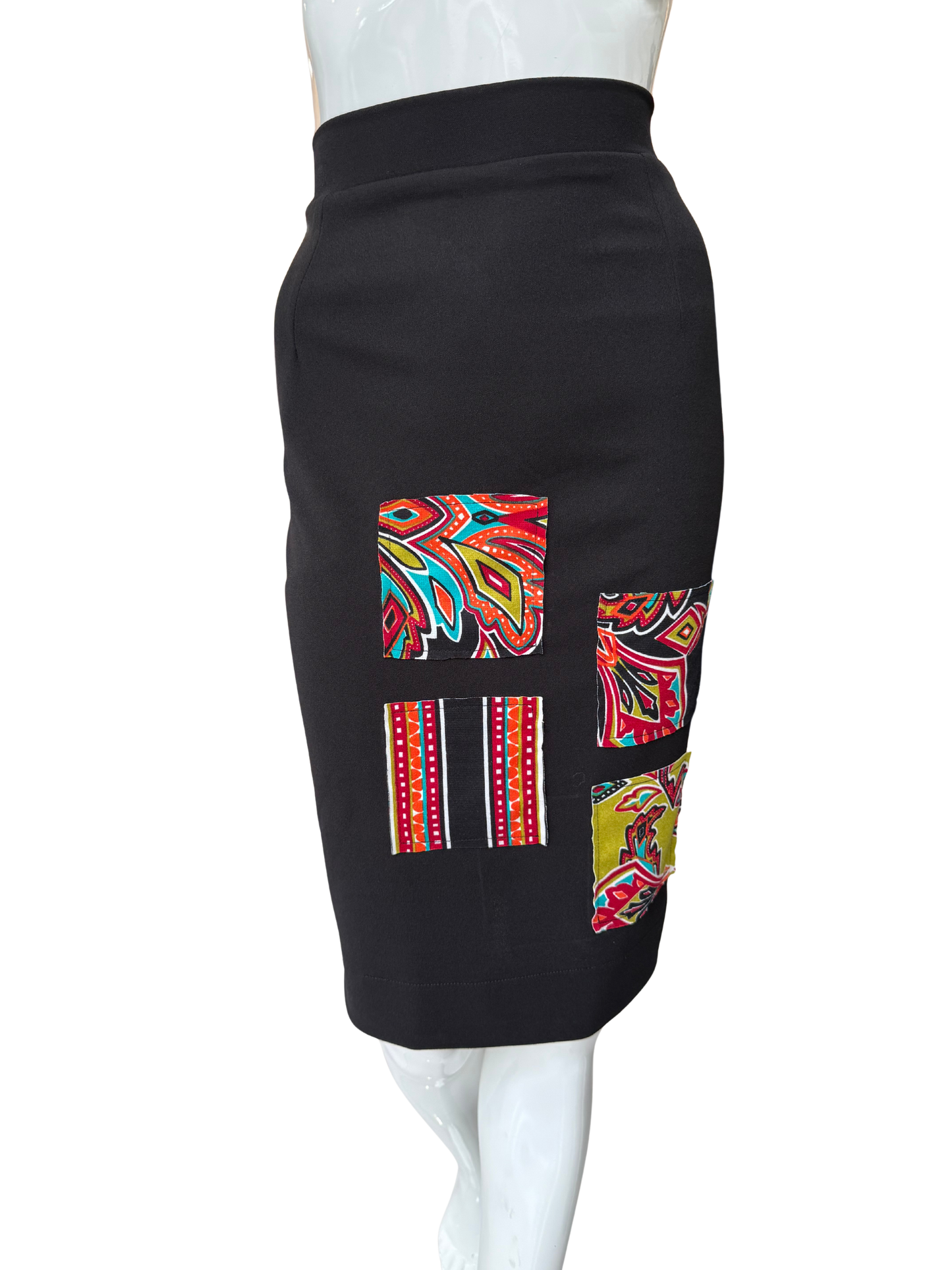 Side view of sleek black pencil skirt showing classic silhouette and knee-length cut with quality construction and comfortable high waistband