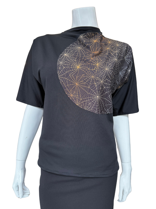 Front view of charcoal exploding dot top featuring intricate geometric pattern with metallic accents and cowl neckline creating stunning visual impact and contemporary appeal