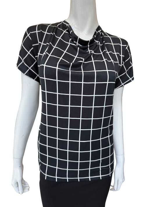 Front view of quality cowl neck top in black and white grid print featuring distinctive tie detail and cap sleeves with modern geometric pattern