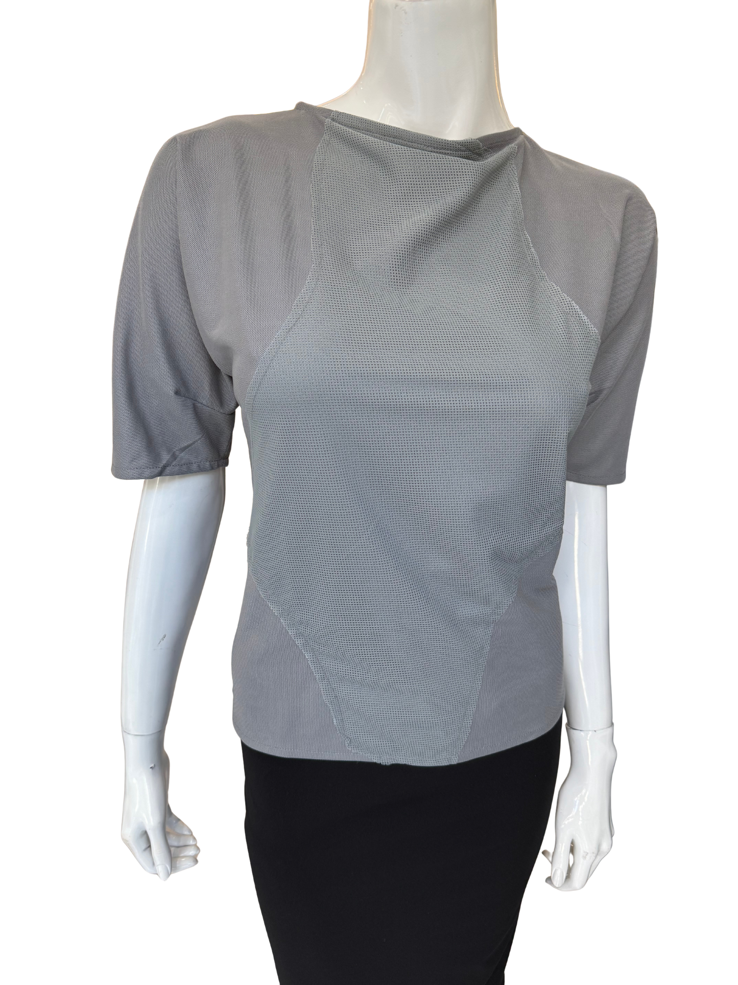 Front view of quality grey patch detail top featuring asymmetrical neckline and distinctive textured panels with elbow-length sleeves and modern design elements