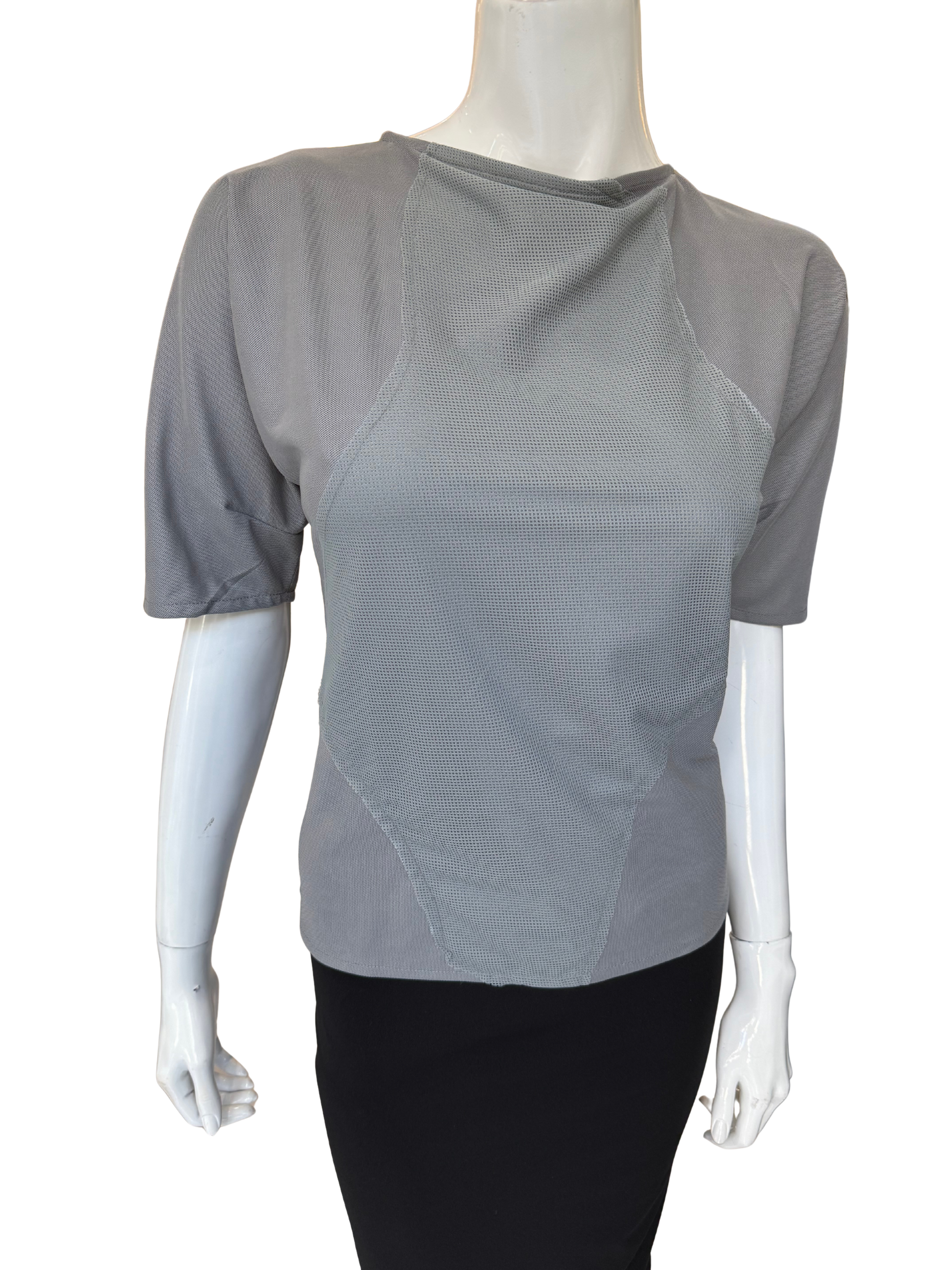 Front view of quality grey patch detail top featuring asymmetrical neckline and distinctive textured panels with elbow-length sleeves and modern design elements