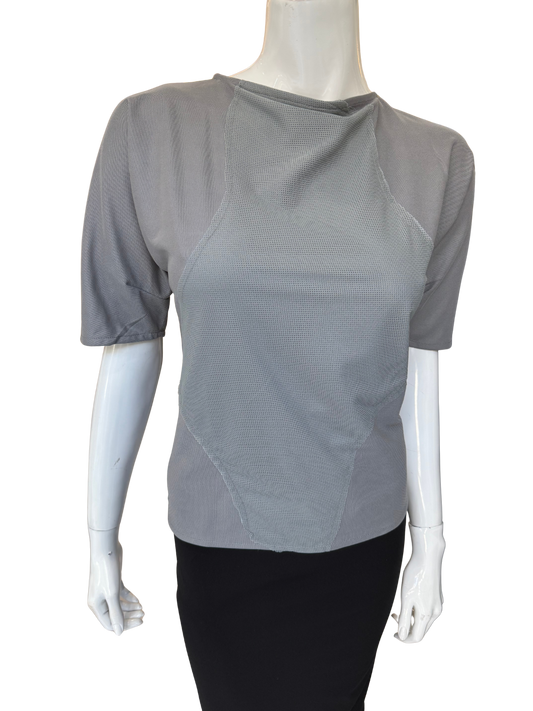 Front view of quality grey patch detail top featuring asymmetrical neckline and distinctive textured panels with elbow-length sleeves and modern design elements
