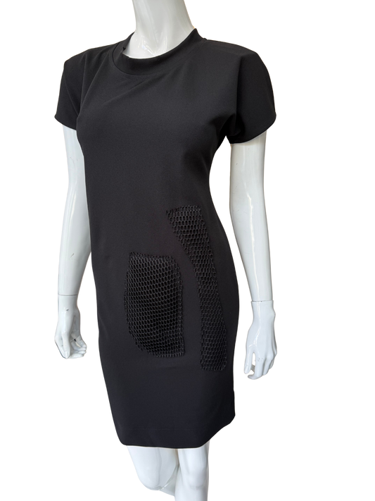 Front view of contemporary black stretch crepe dress featuring bold mesh panel details and modern minimalist design with striking visual texture