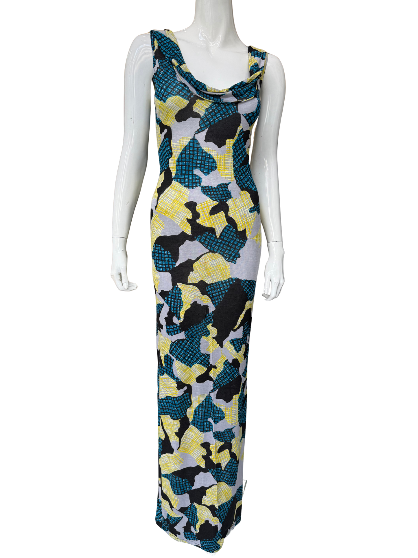 Front view of striking abstract print maxi dress featuring vibrant teal, yellow, black and grey geometric pattern with cowl neckline and floor-length silhouette