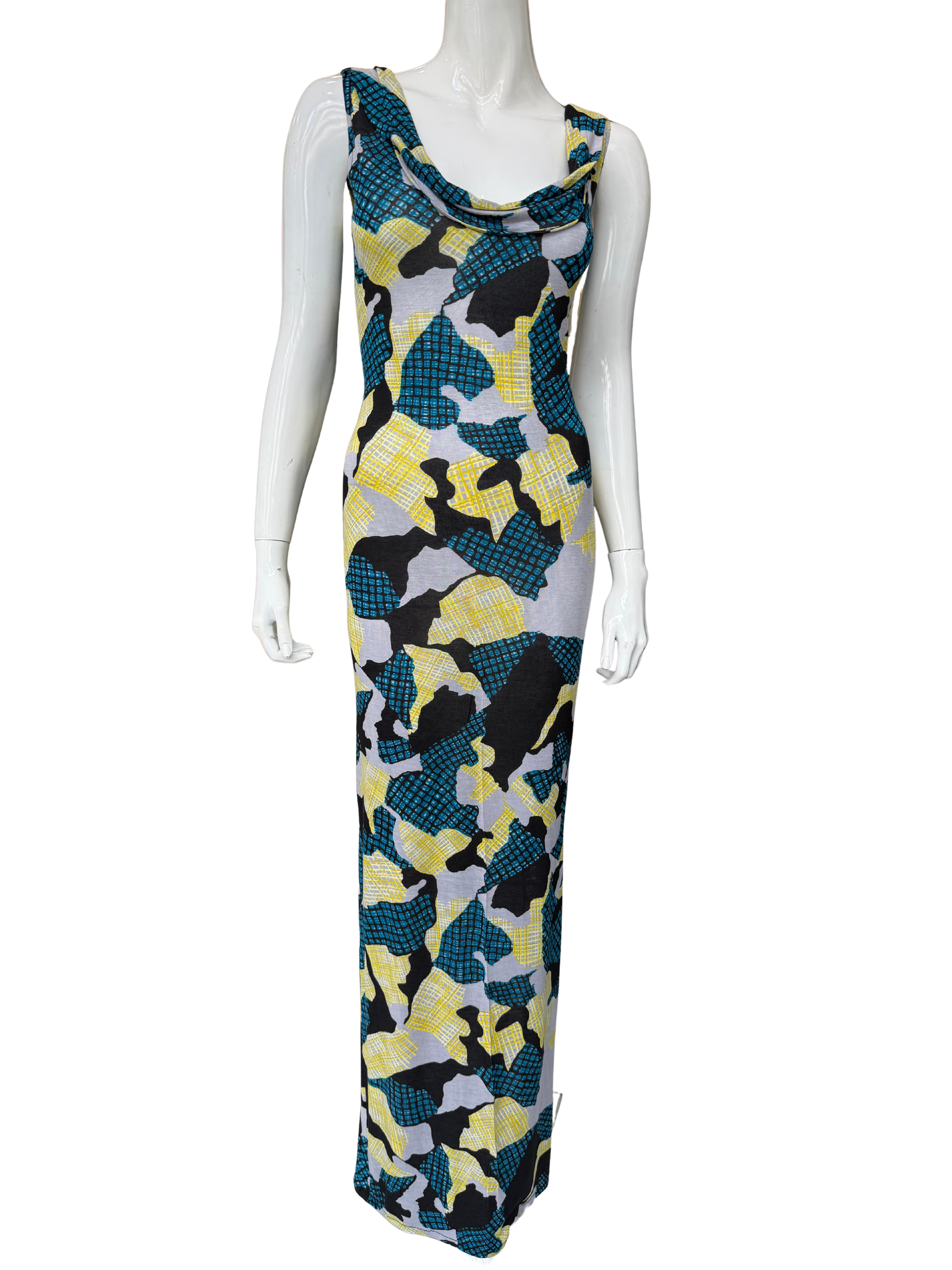 Front view of striking abstract print maxi dress featuring vibrant teal, yellow, black and grey geometric pattern with cowl neckline and floor-length silhouette
