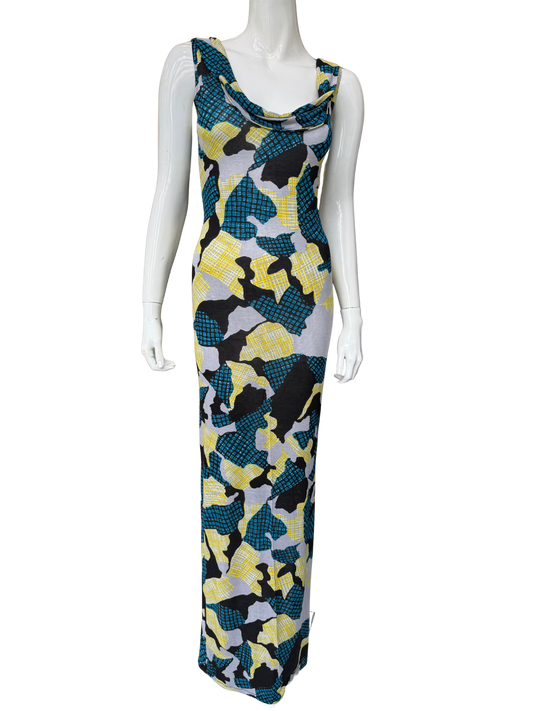 Front view of striking abstract print maxi dress featuring vibrant teal, yellow, black and grey geometric pattern with cowl neckline and floor-length silhouette