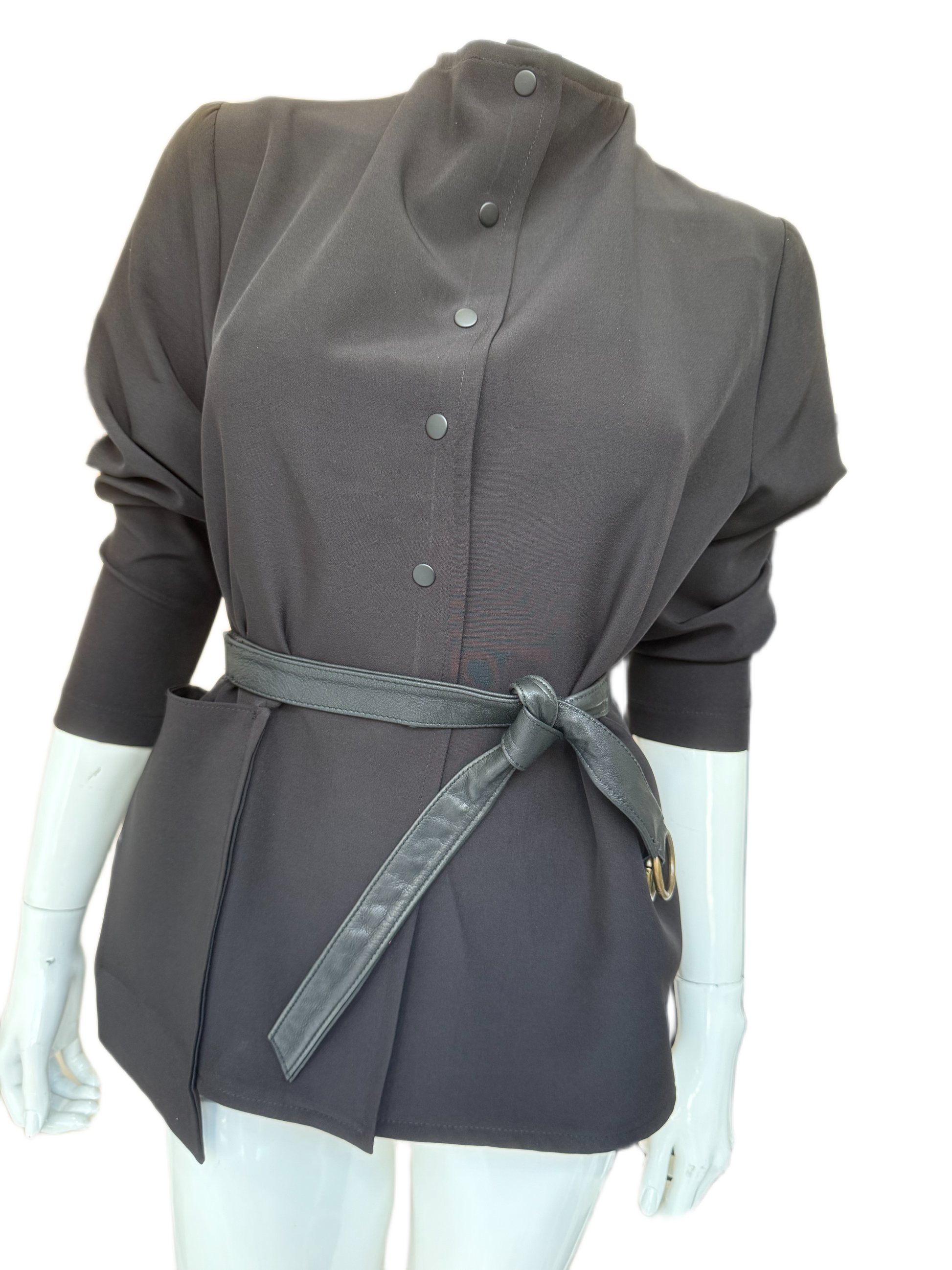 Contemporary calf leather wrap belt with gold hardware styled around charcoal jacket, showing modern silhouette definition