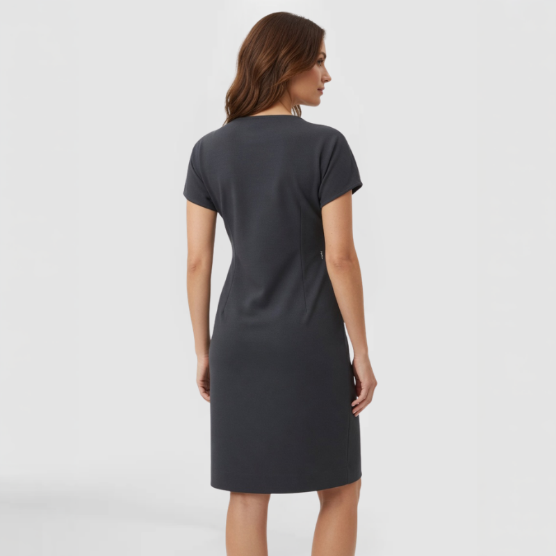 Back view of short-sleeve knit crepe dress in deep charcoal showing continuous textured lace appliqué wrapping from the hip around the back of the garment. Made by SWABY - A Chicago Fashion Designer.