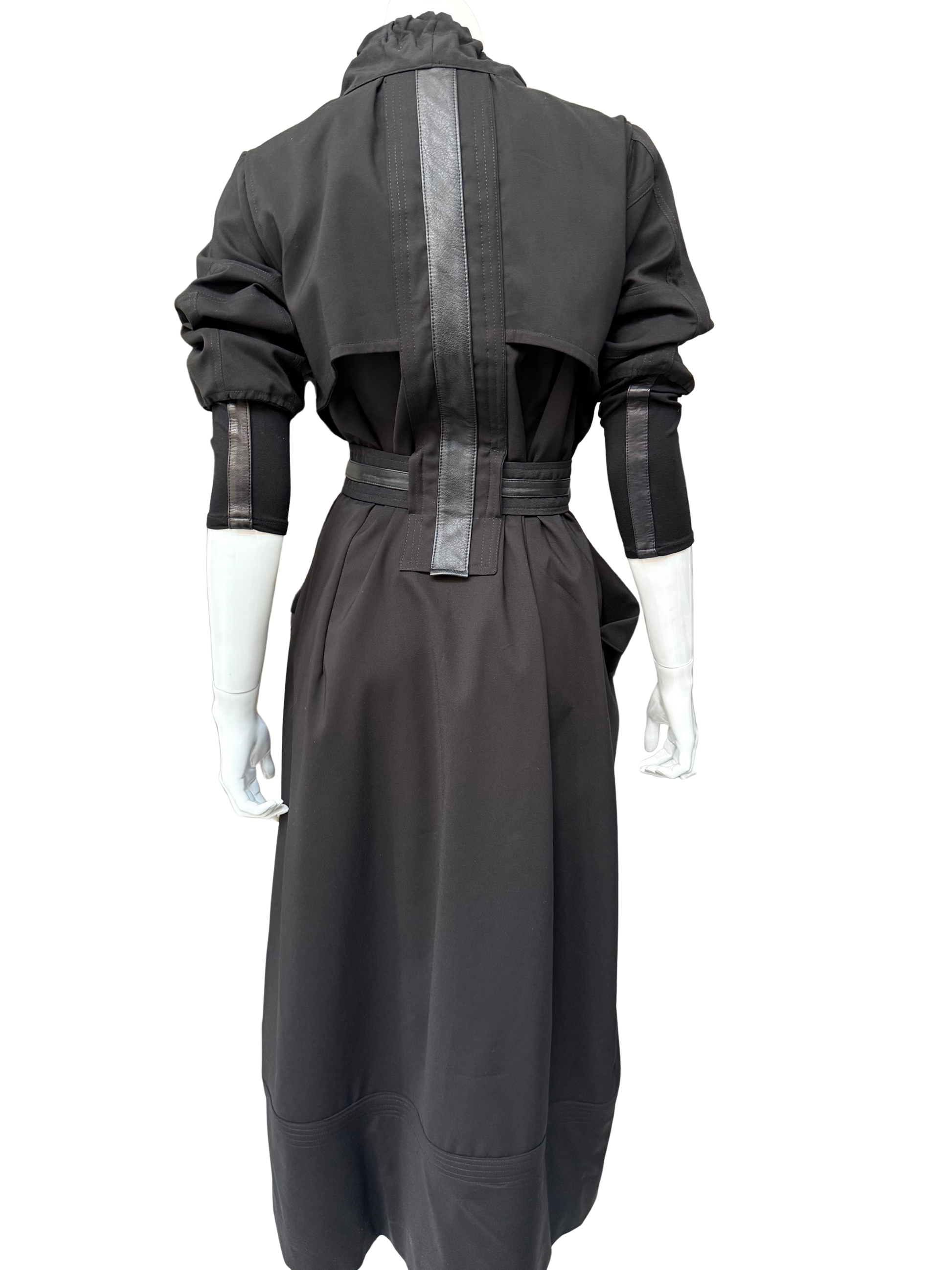 Back view of charcoal gray Mary Jane Jacket showing long trench silhouette with metallic leather trim details and adjustable belt on mannequin