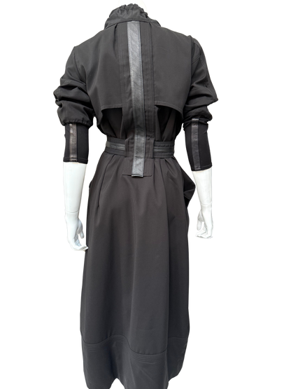 Back view of charcoal gray Mary Jane Jacket showing long trench silhouette with metallic leather trim details and adjustable belt on mannequin