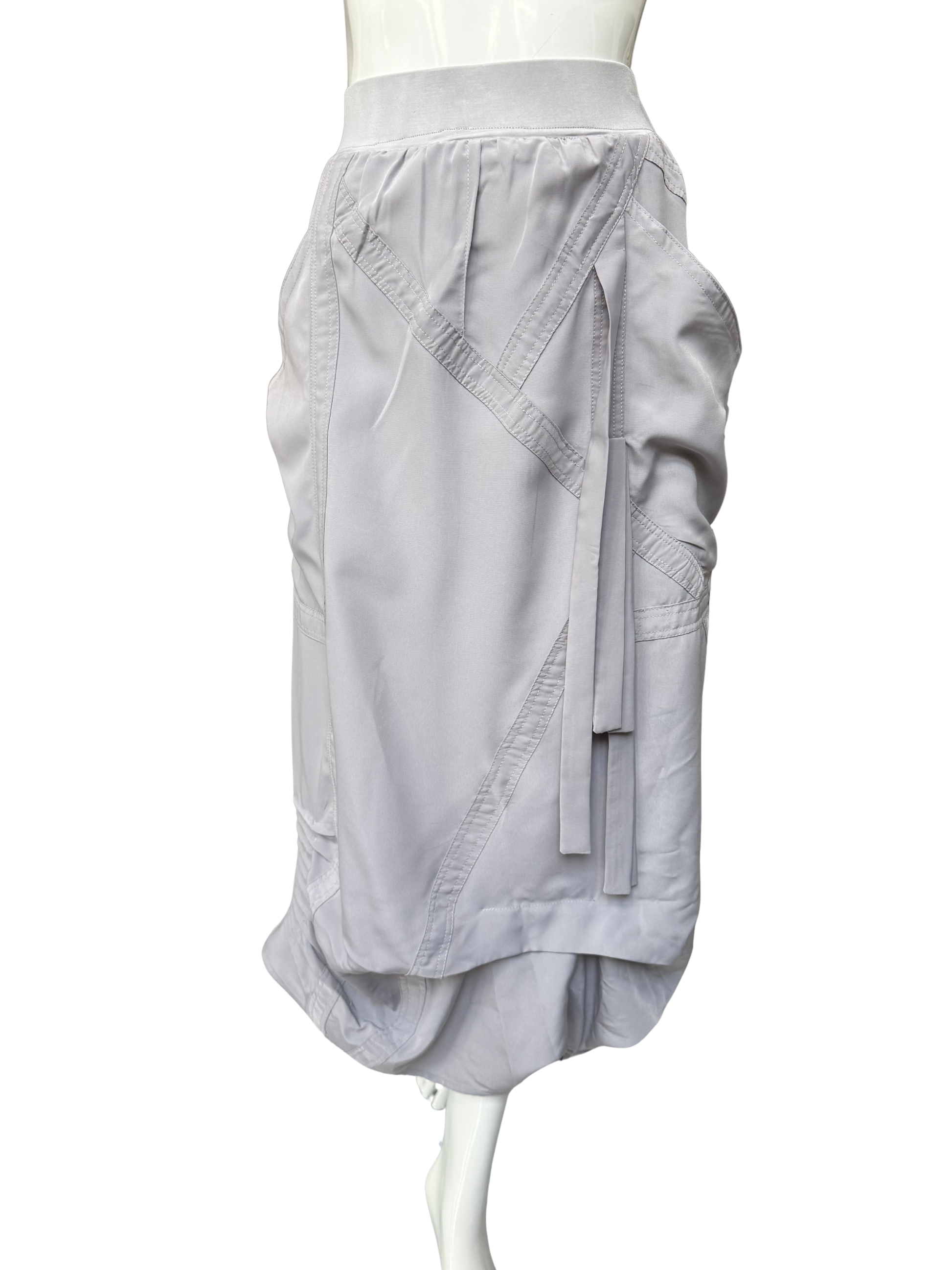 Close-up of white Blaine Skirt showing diagonal seam construction, adjustable drawstring details, and refined high-waistband design