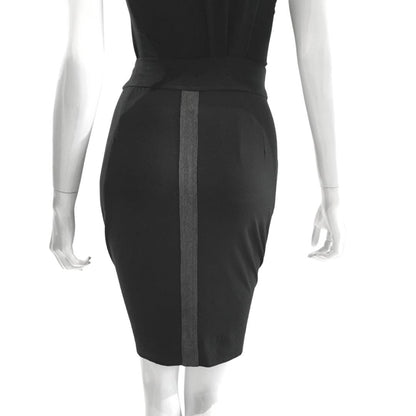 Rear view of a sophisticated two-tone knit skirt with distinctive geometric strap detailing and refined midi length for professional and social occasions