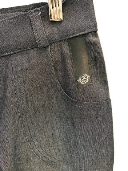 A close up view of the SWABY emblem on the left side pocket of a pair of SWABY Wide Leg Jeans.