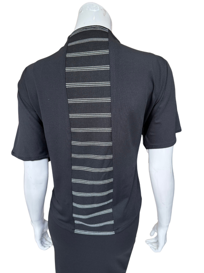 Back view of striking striped center knit top in charcoal showing vertical white striped panel detail and quality knit construction with short sleeves