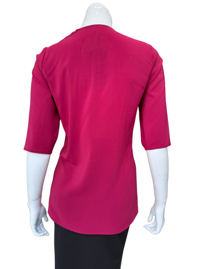 Back view of bold cranberry stretch chiffon blouse showing clean construction and 3/4 sleeves with vibrant color and quality fabric details