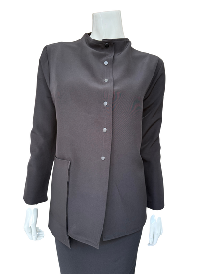 Front view of essential woven jacket featuring distinctive snap front closure and modern stand collar in versatile charcoal tone
