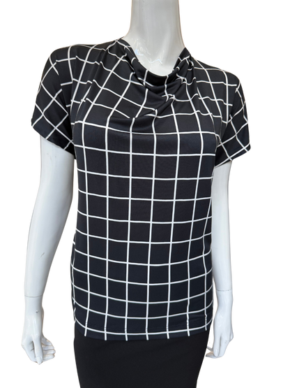 Front view of quality cowl neck top in black and white grid print featuring distinctive tie detail and cap sleeves with modern geometric pattern