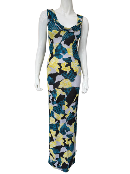 Front view of striking abstract print maxi dress featuring vibrant teal, yellow, black and grey geometric pattern with cowl neckline and floor-length silhouette