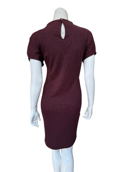 Back view of burgundy ribbed knit dress showing keyhole detail and quality textured fabric construction with sophisticated modern appeal