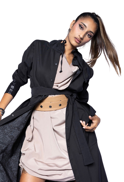 Model wearing black Mary Jane Jacket open over neutral outfit, showcasing dramatic collar detail and sophisticated layering with statement belt