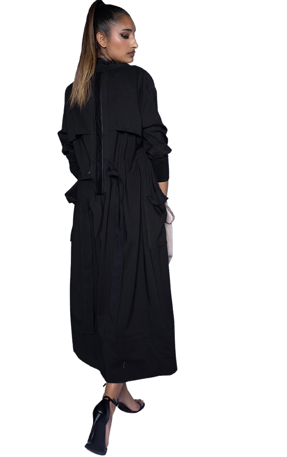 Model wearing black Mary Jane Jacket cinched at waist, showing full-length silhouette and refined trench styling for evening wear