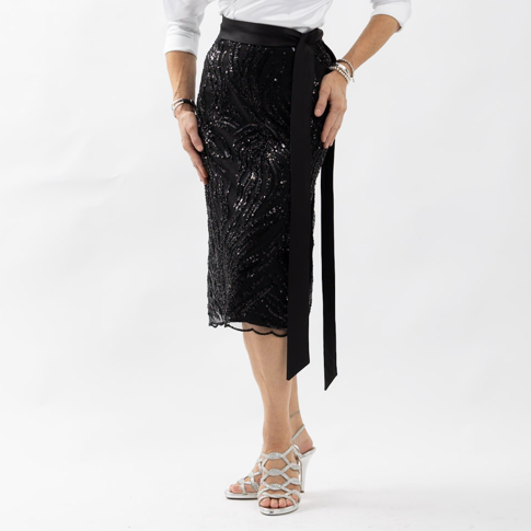 Close up view of the black Paige skirt showing the shimmer of beaded sequins on silk fabric