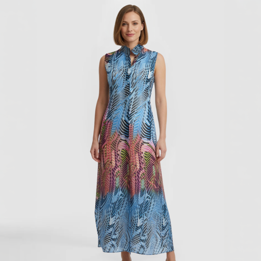 Sleeveless maxi shirt dress in blue and coral palm leaf print with mandarin collar, open neckline, and flowing A-line silhouette. Made by SWABY - A New York Fashion Designer.