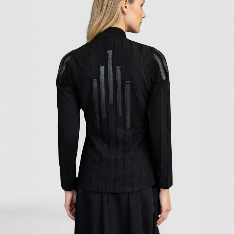 A back view of the Trinity Sweater, by SWAY - a New York Fashion Designer, shown here on a blonde fashion model featuring hand-made surface lines and leather trim accents down the back and on the shoulders