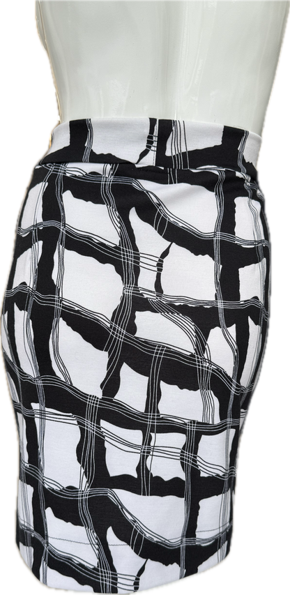 Back view of geometric print knit crepe skirt displaying striking black and white pattern with contemporary abstract design and comfortable fit
