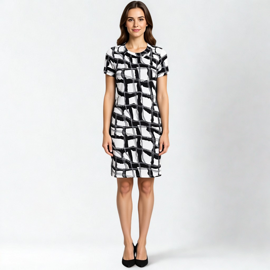 A SWABY model poses in a distinctive  black and white patterned dress, knee-length and short sleeves