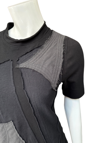 Close-up of black DeAnna Dress showing raw-edge gray patchwork details, mock turtleneck, and cotton lycra construction on mannequin