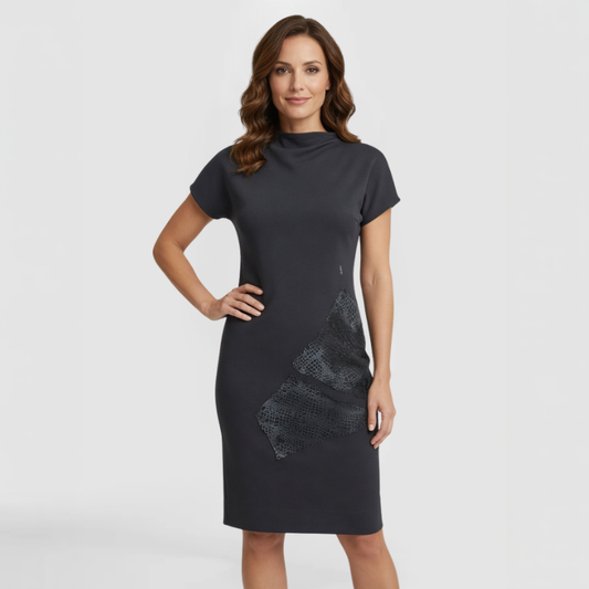 Short-sleeve knee-length dress in deep charcoal knit crepe with mock neckline and textured lace appliqué detail at the left hip. Made by SWABY - A Chicago Fashion Designer.
