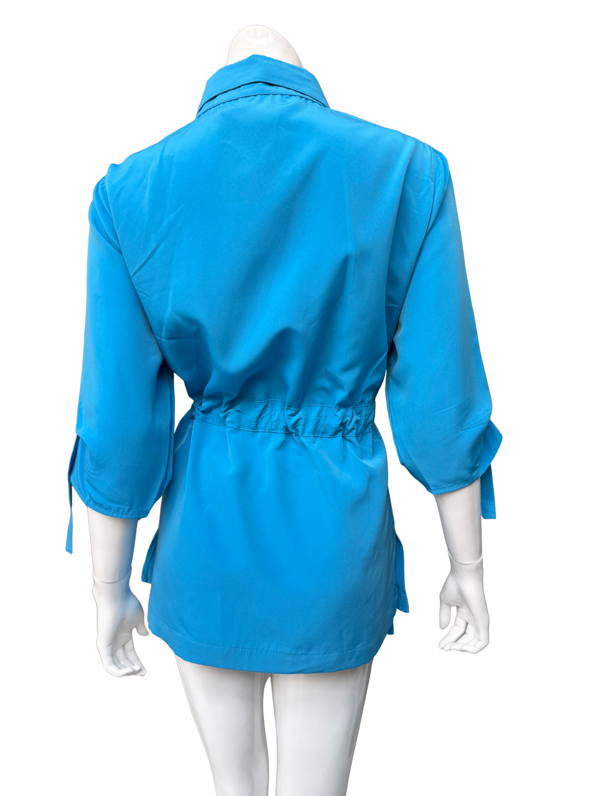 Vibrant aqua blue Molli Top button-front blouse shown from back on mannequin, featuring drawstring waist detail and three-quarter sleeves with tie details