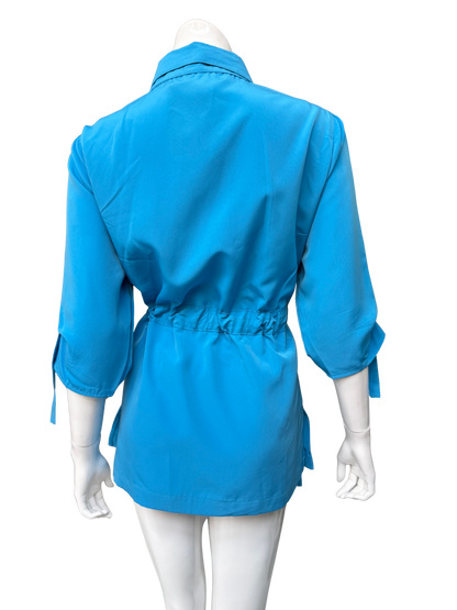 Vibrant aqua blue Molli Top button-front blouse shown from back on mannequin, featuring drawstring waist detail and three-quarter sleeves with tie details