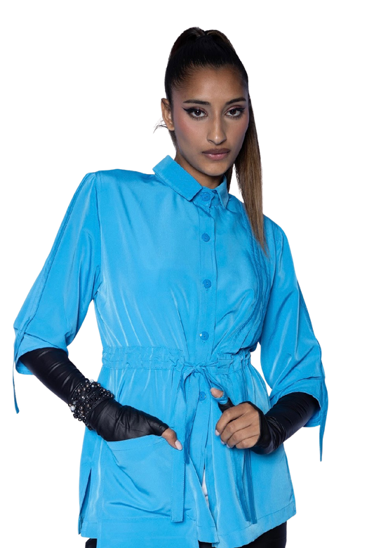 Model wearing aqua blue Molli Top drawstring blouse with black leather opera gloves, showing sophisticated styling and tailored waist silhouette