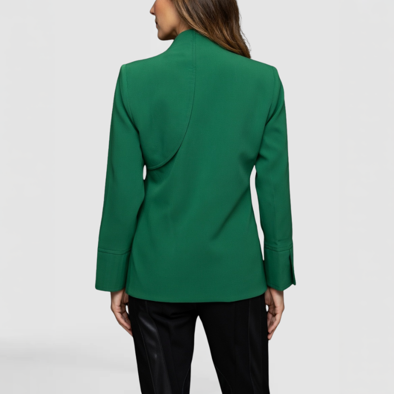 A SWABY fashion model poses to show the back of the Sadie Jacket complete with asymmetrical shoulder design. A perfect jacket for springtime.