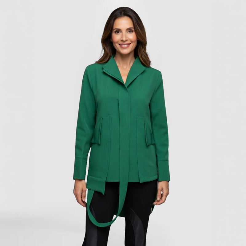 A fashion model poses in the Sadie Jacket, by New York Fashion Designer SWABY, - a vibrant emerald green jacket that is perfect for the office, events and evenings. A statement piece for spring.