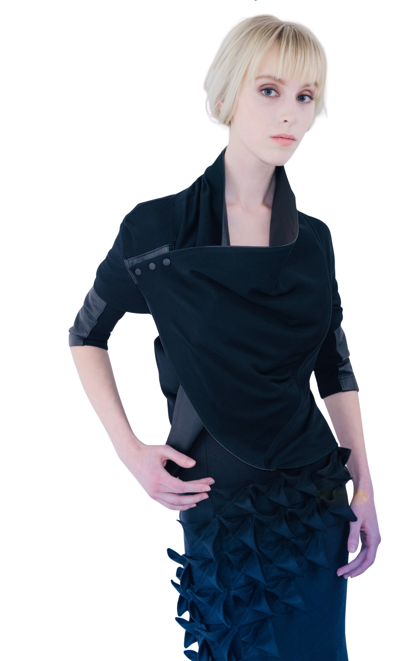 A blonde model poses in a wrap matte. jersey top with leather details and snap closure 