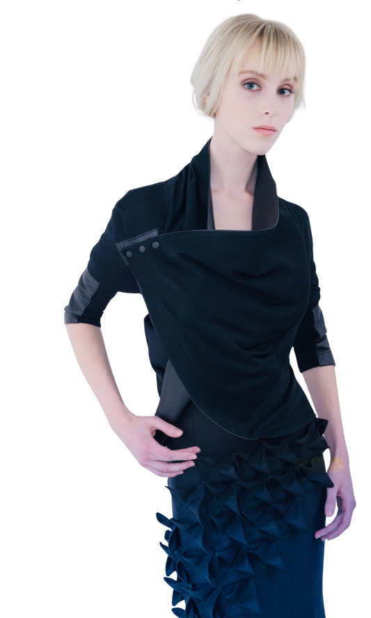 A blonde model poses in a wrap matte. jersey top with leather details and snap closure 